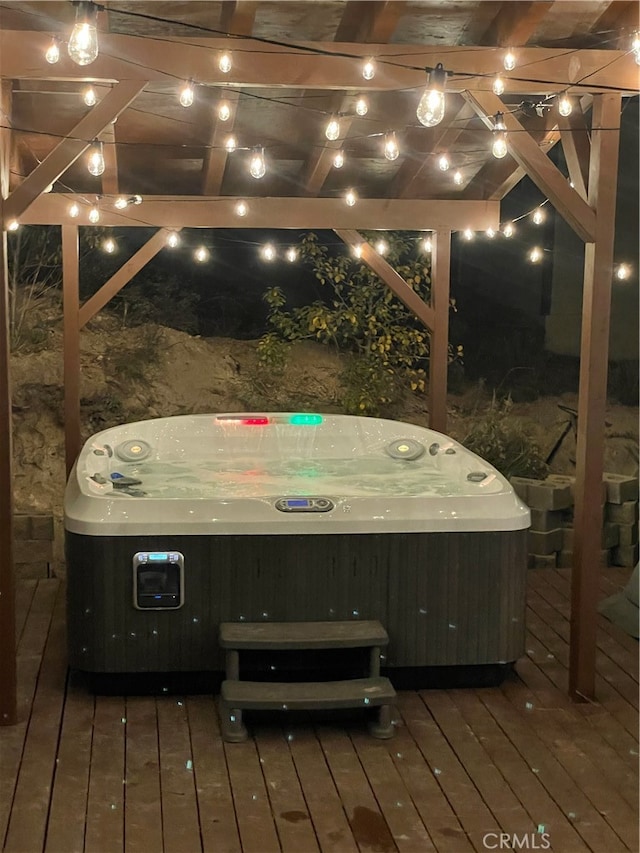 wooden deck featuring a hot tub