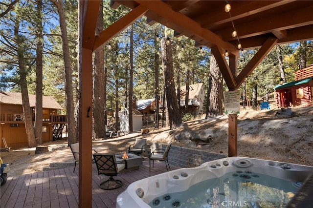 wooden deck featuring an outdoor hot tub