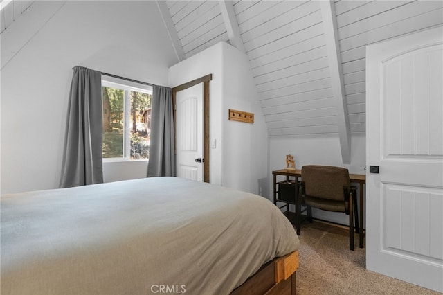 bedroom with carpet flooring and vaulted ceiling with beams