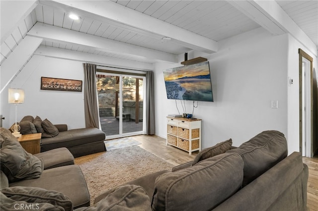 living room featuring beam ceiling and light wood-type flooring