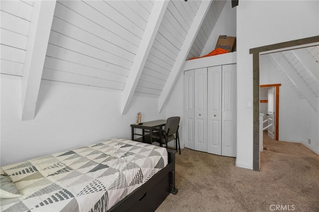 bedroom featuring carpet, vaulted ceiling with beams, a closet, and wooden ceiling