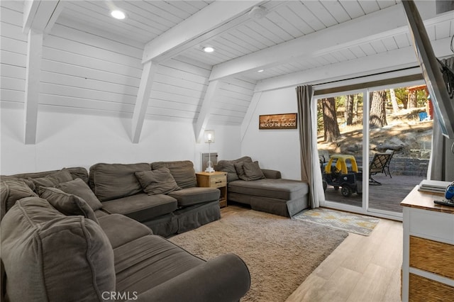 living room featuring vaulted ceiling with beams, light hardwood / wood-style flooring, and wooden ceiling