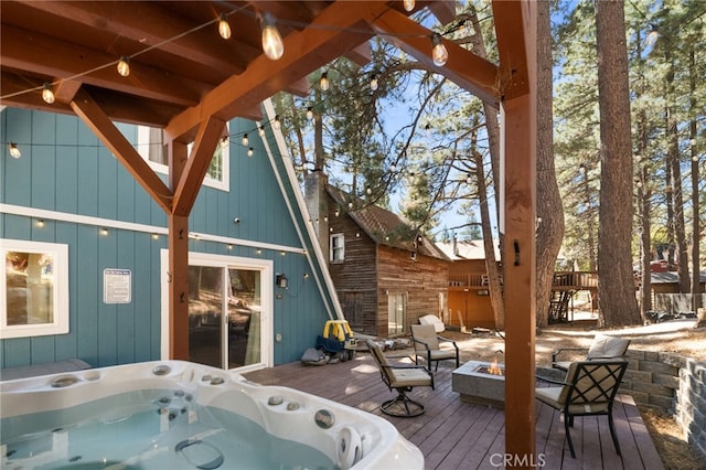 deck with an outdoor hot tub