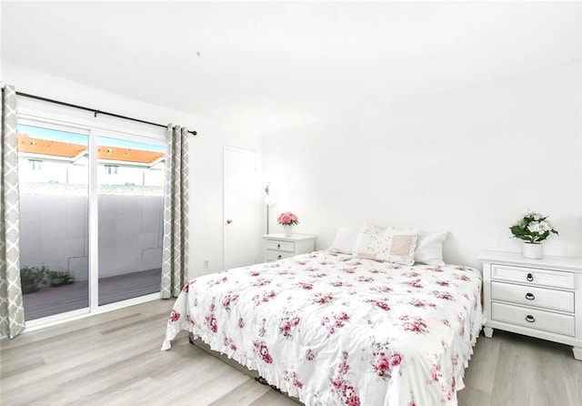 bedroom featuring light hardwood / wood-style flooring and access to outside