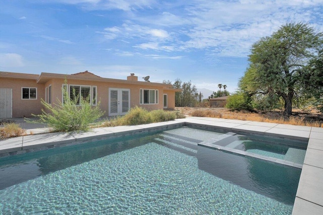 view of swimming pool with an in ground hot tub