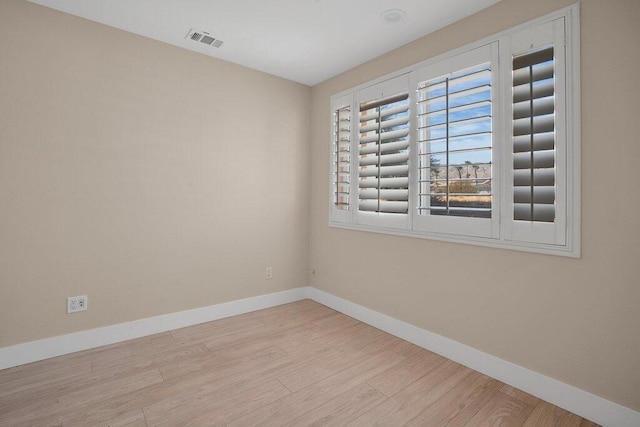 unfurnished room with light hardwood / wood-style flooring