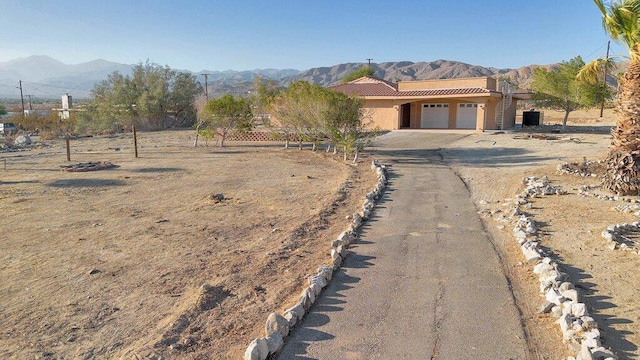 view of front of home with a mountain view and a garage