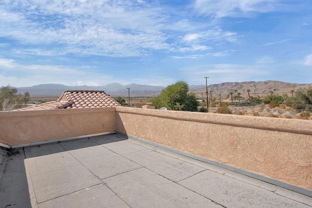 view of patio / terrace with a mountain view and a balcony