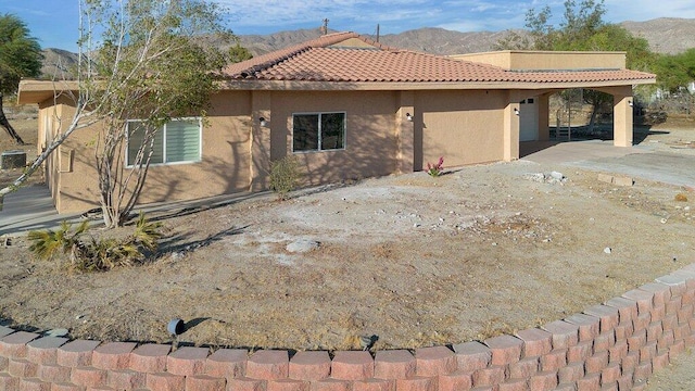 view of front facade featuring a patio and a mountain view