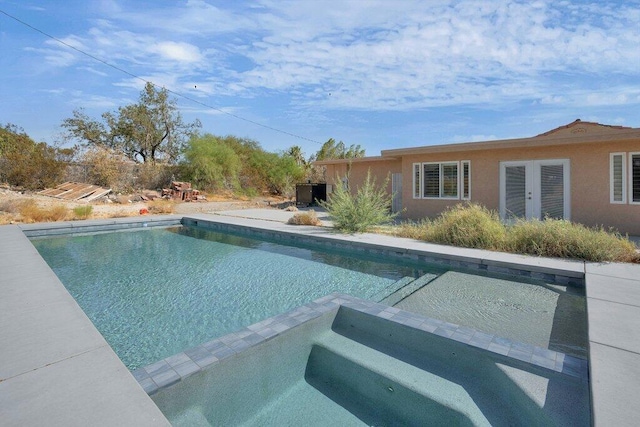 view of swimming pool featuring an in ground hot tub