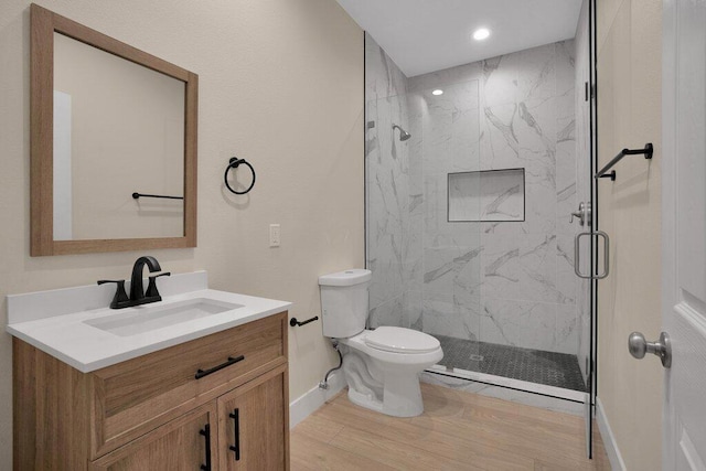 bathroom with vanity, walk in shower, toilet, and wood-type flooring