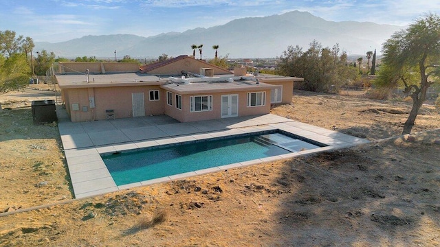 rear view of property featuring a patio and a mountain view