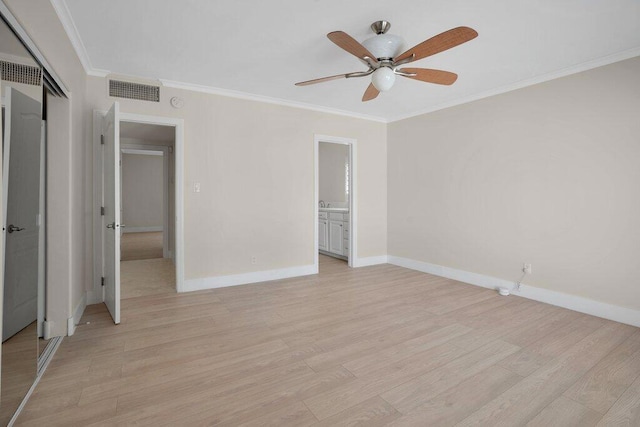 unfurnished bedroom featuring ornamental molding, light hardwood / wood-style flooring, a closet, and ceiling fan