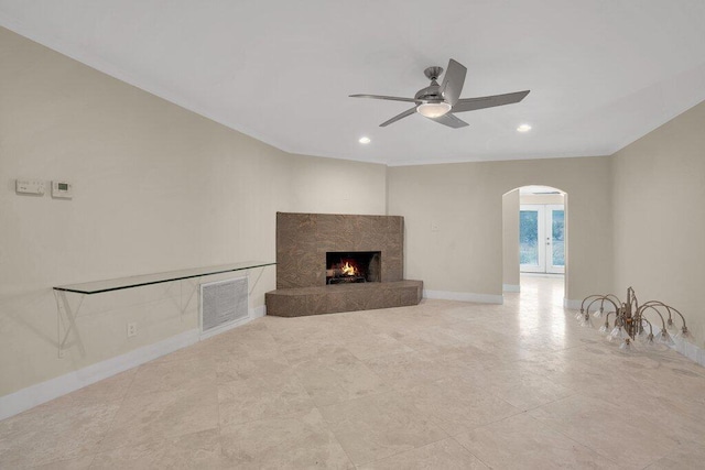 unfurnished living room featuring ceiling fan and a high end fireplace