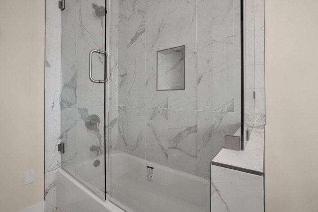 bathroom with vanity and enclosed tub / shower combo