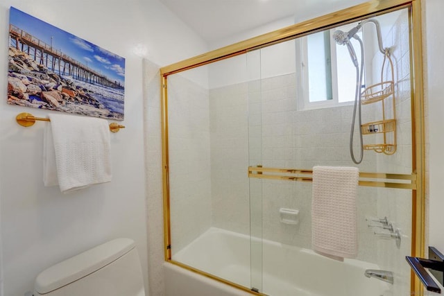 bathroom featuring toilet and enclosed tub / shower combo