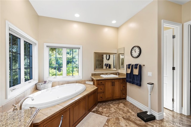 bathroom featuring vanity and a tub to relax in