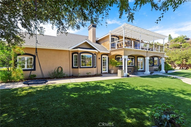 back of house featuring a yard, a patio, and a balcony