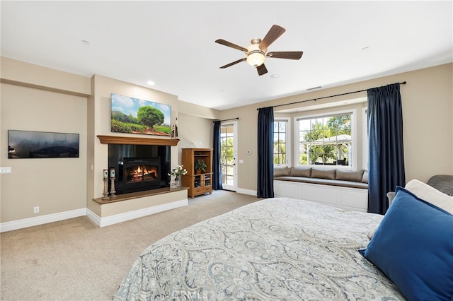 bedroom with ceiling fan, light carpet, and access to outside