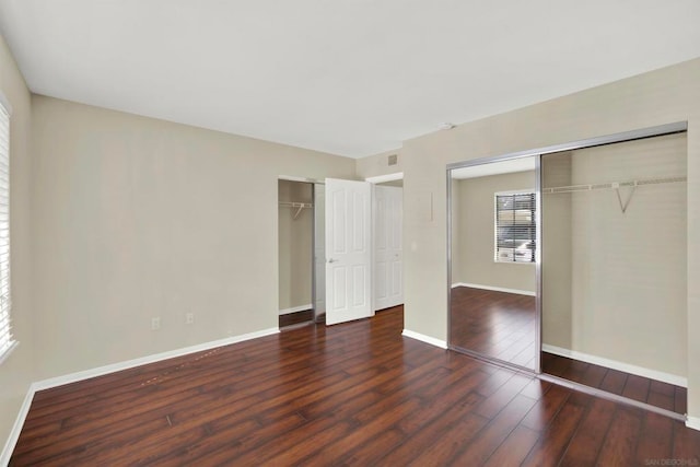 unfurnished bedroom with dark hardwood / wood-style floors