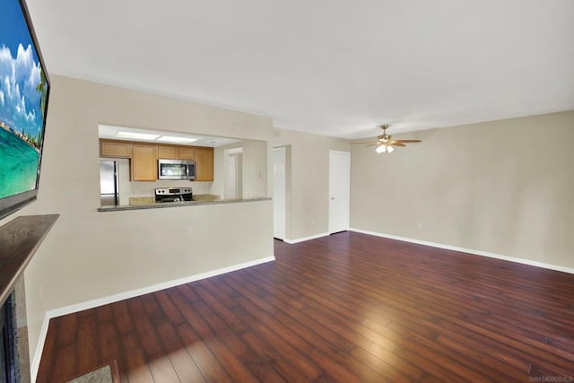 unfurnished living room with dark hardwood / wood-style floors and ceiling fan