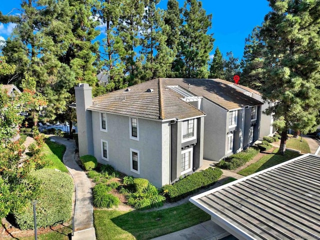 view of property exterior with a lawn