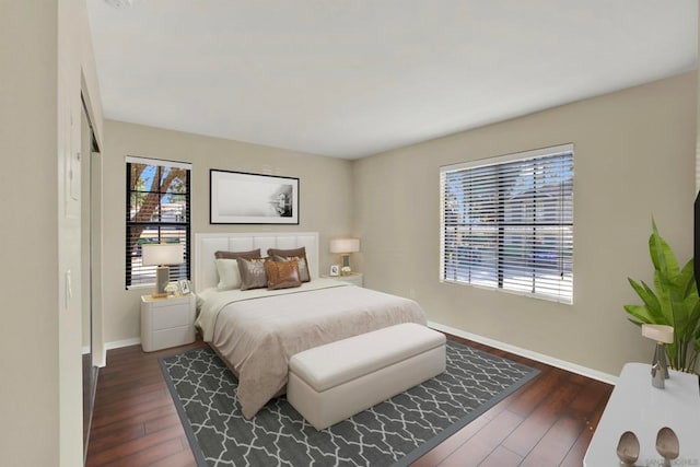 bedroom with dark hardwood / wood-style floors