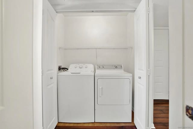 laundry room featuring washer and dryer and dark hardwood / wood-style flooring