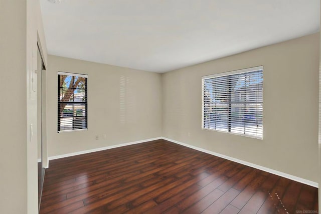 empty room featuring dark hardwood / wood-style flooring