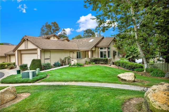 view of front of house with a front yard and a garage