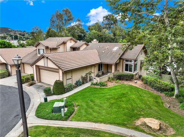 view of front of house with a garage and a front lawn