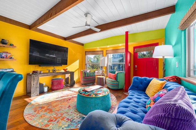 living room featuring lofted ceiling with beams, wood-type flooring, and ceiling fan