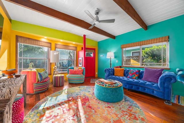 living room with dark wood-type flooring, ceiling fan, and vaulted ceiling with beams