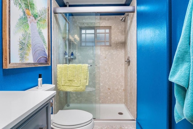 bathroom featuring vanity, toilet, and an enclosed shower