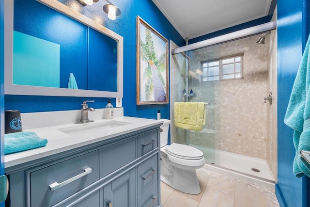 bathroom with toilet, a shower with shower door, vanity, and tile patterned flooring