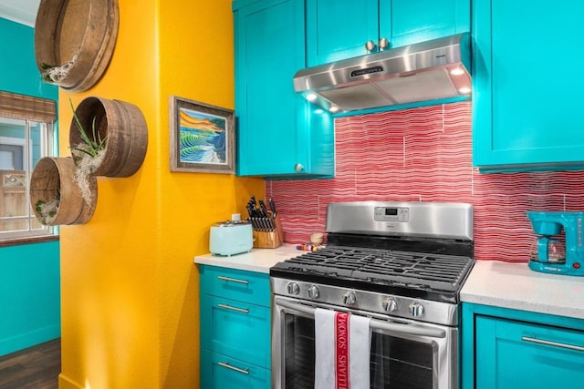 kitchen with blue cabinetry, dark wood-type flooring, and stainless steel gas range