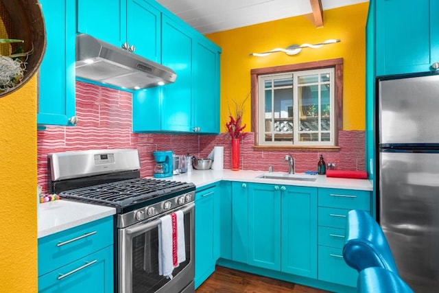 kitchen with tasteful backsplash, appliances with stainless steel finishes, sink, dark hardwood / wood-style flooring, and blue cabinetry