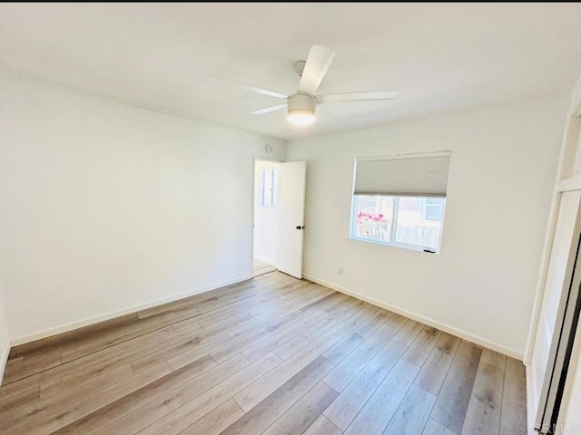 empty room with light hardwood / wood-style flooring and ceiling fan