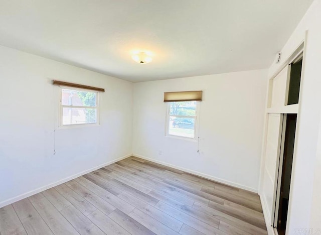 unfurnished room featuring light hardwood / wood-style flooring and plenty of natural light