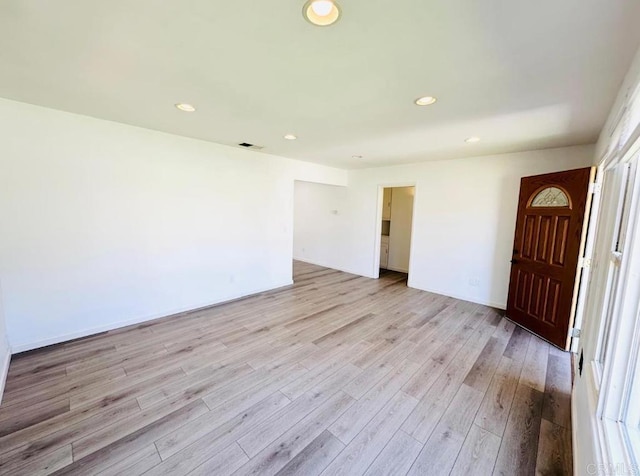 unfurnished room with light wood-type flooring