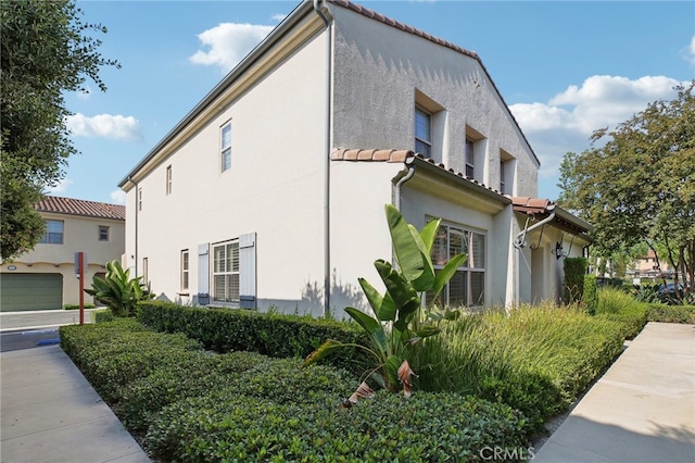 view of side of property with a garage