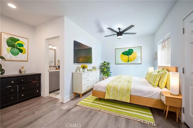 bedroom featuring ceiling fan, connected bathroom, and wood finished floors