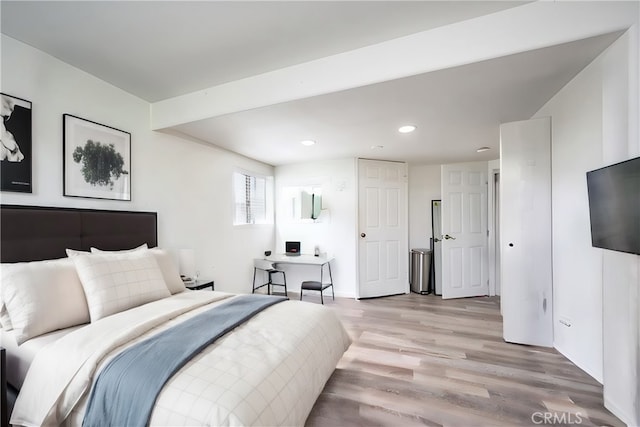 bedroom with light wood-style floors and recessed lighting