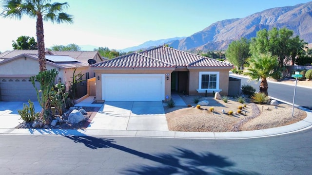 view of front of property featuring a mountain view and a garage