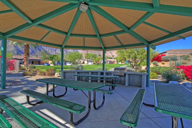 surrounding community featuring a gazebo, exterior kitchen, and a patio