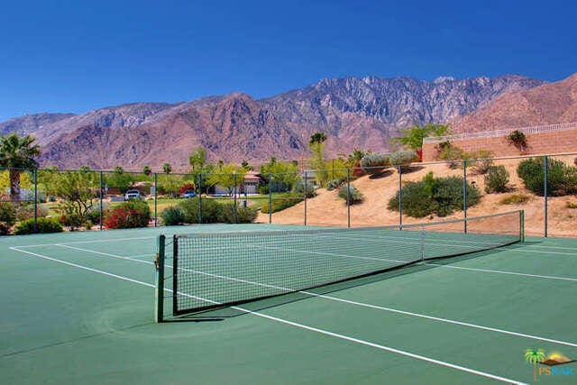 view of tennis court featuring a mountain view