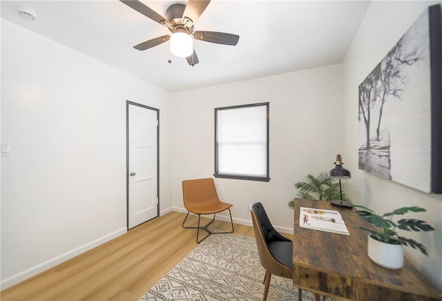 office with wood-type flooring and ceiling fan