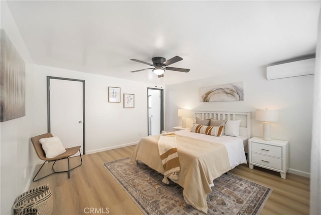 bedroom featuring light hardwood / wood-style flooring, a wall mounted AC, and ceiling fan