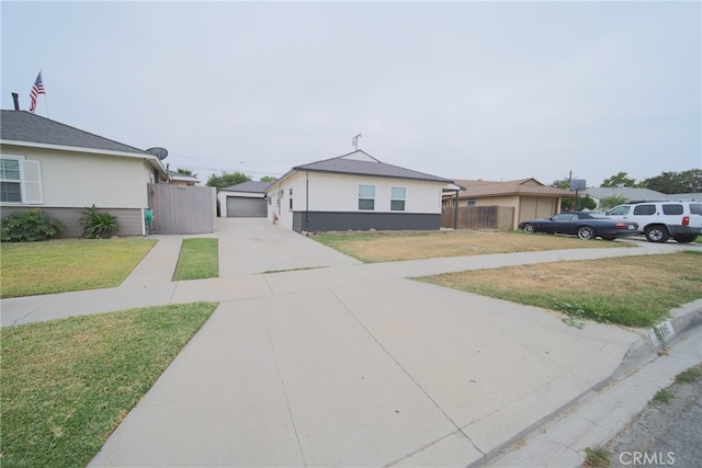 ranch-style home with a front lawn and a garage