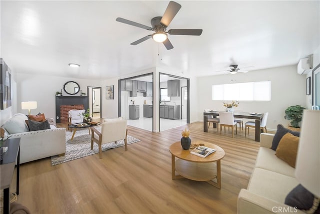 living room featuring light hardwood / wood-style flooring and ceiling fan